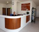 The friendly receptionist welcomes patients to the hospital